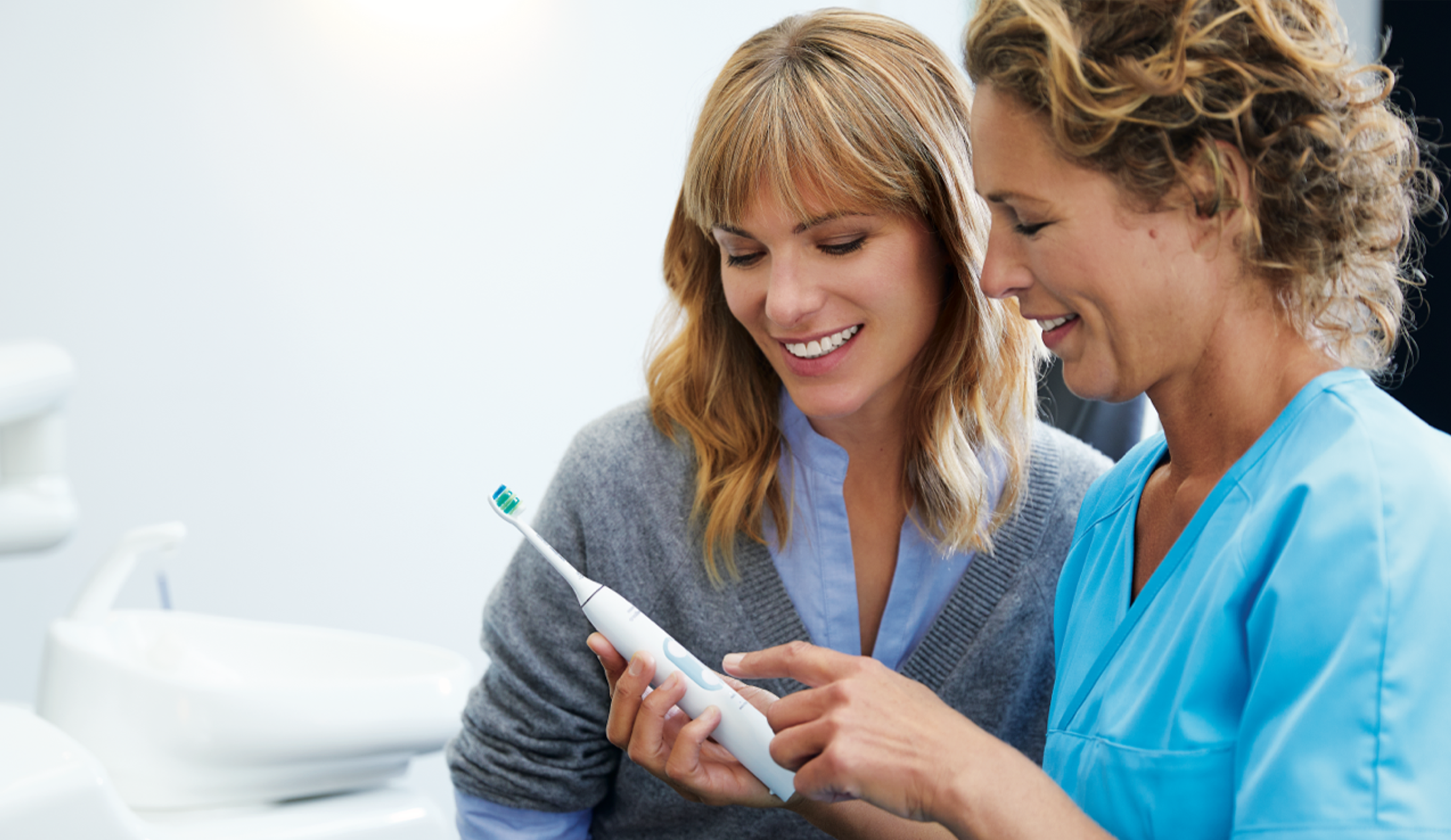 Dental professional showing how to brush Sonicare power.