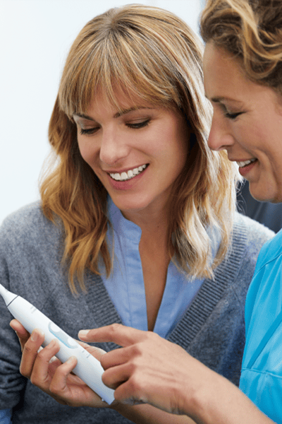 Dental professional showing how to brush Sonicare power.