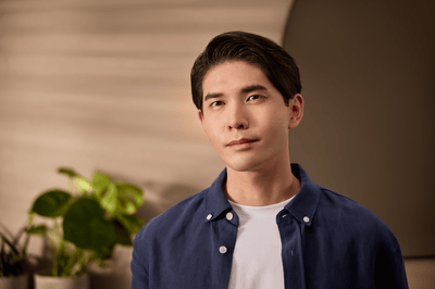 A man with a cleanly shaved face looks directly at the camera after he has shaved properly.