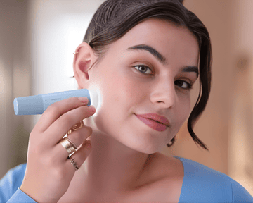 Woman shaving her face