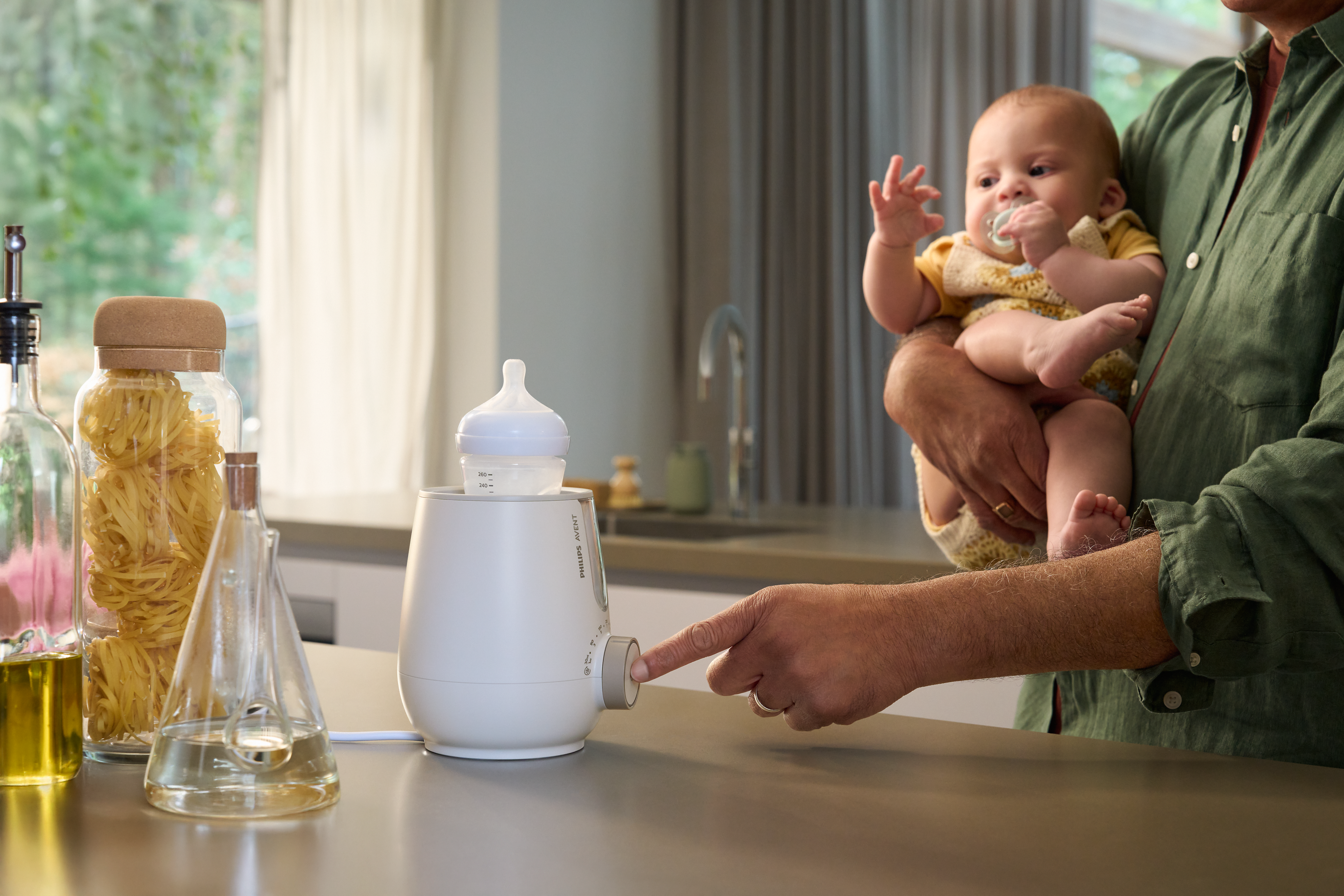 Parent using Premium 2-in-1 Warmer & Sterilizer