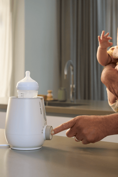Parent using Premium 2-in-1 Warmer & Sterilizer
