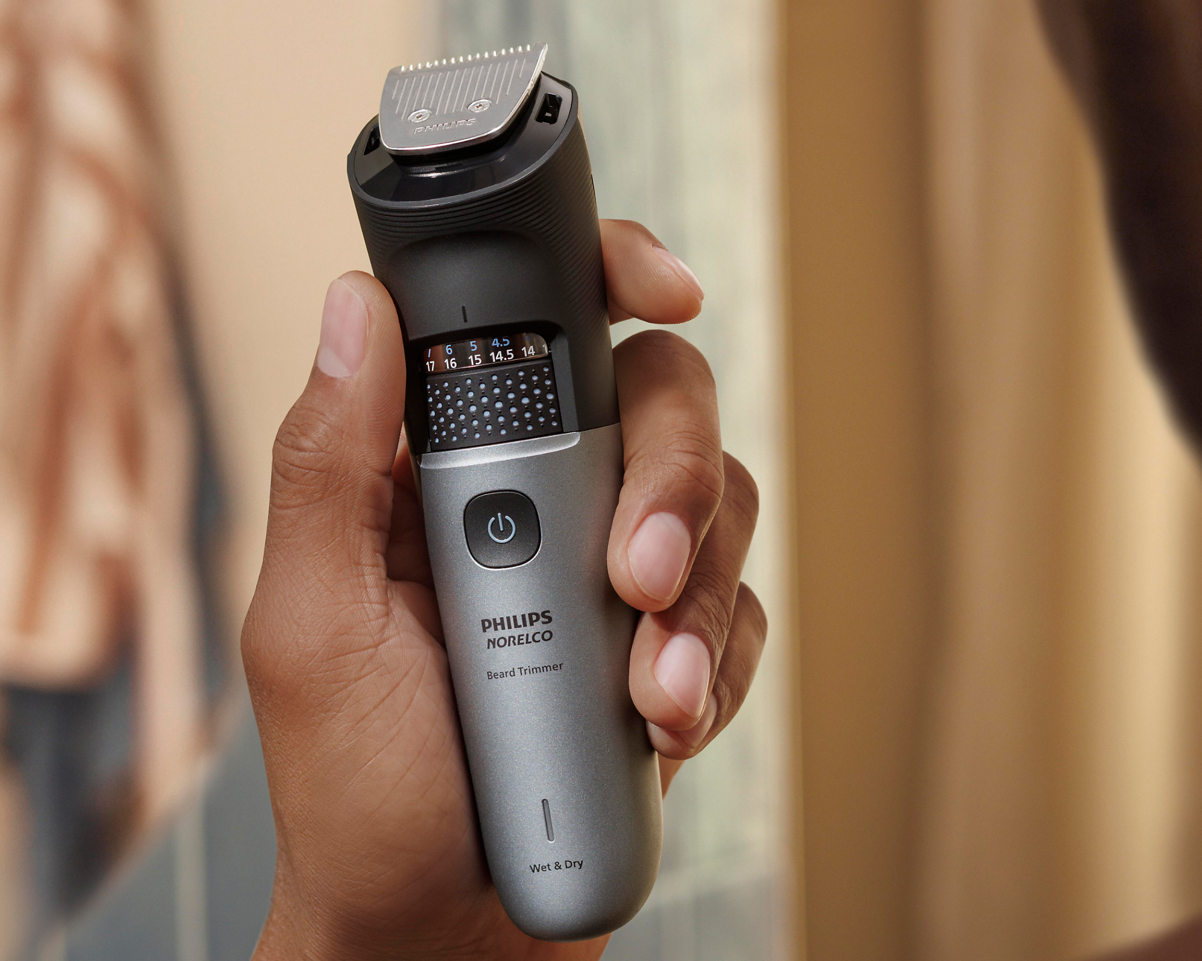 Man holds waterproof Beard Trimmer 7000 in shower