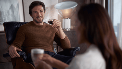 Man with well-shaped beard smiling at café