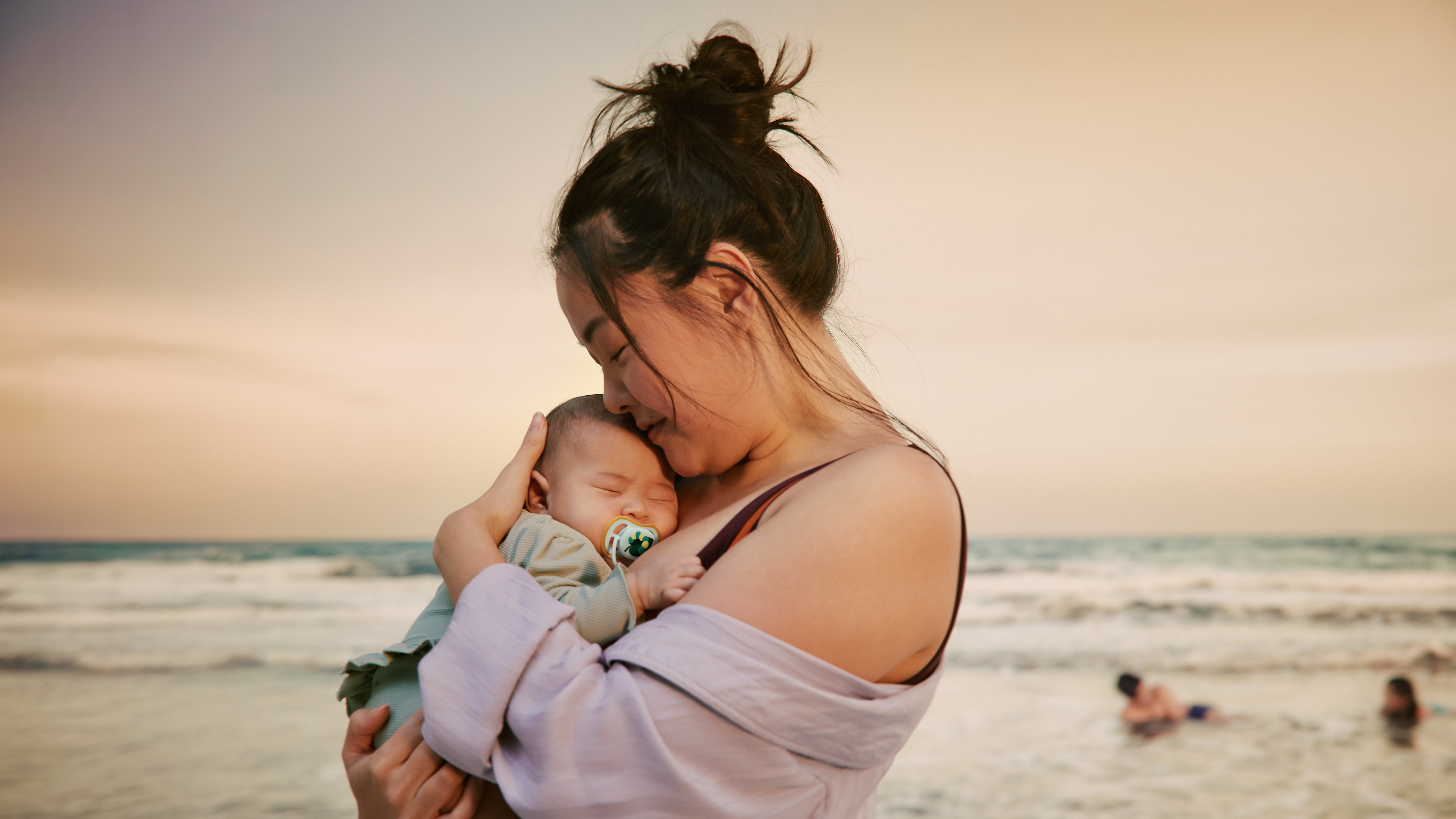 Mom is reading a book to her toddler