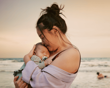 Mom is reading a book to her toddler