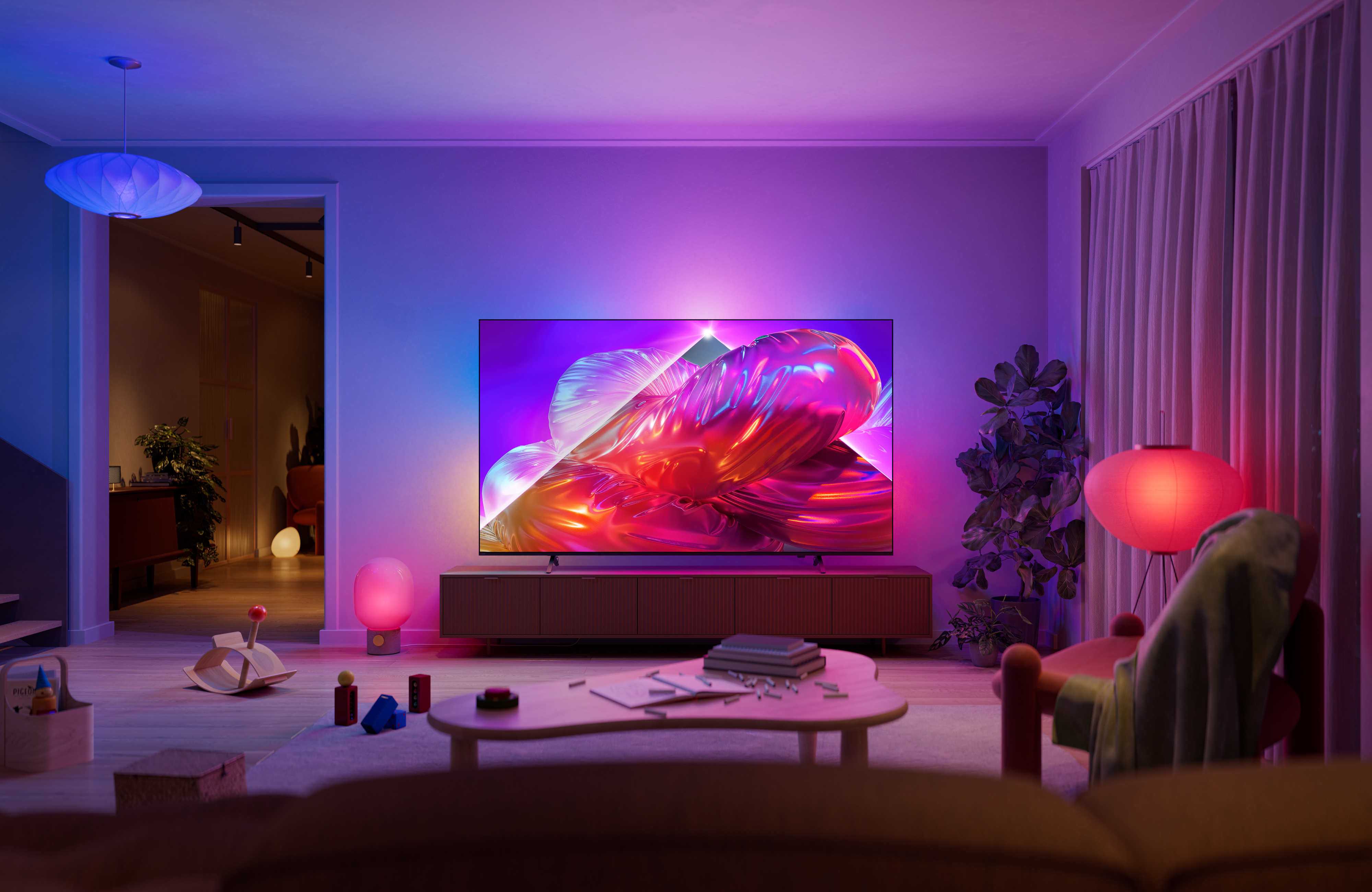Philips Ambilight TV in a modern living room, displaying vibrant abstract artwork while matching pink, purple, and blue ambient lighting extends onto the wall behind the screen.