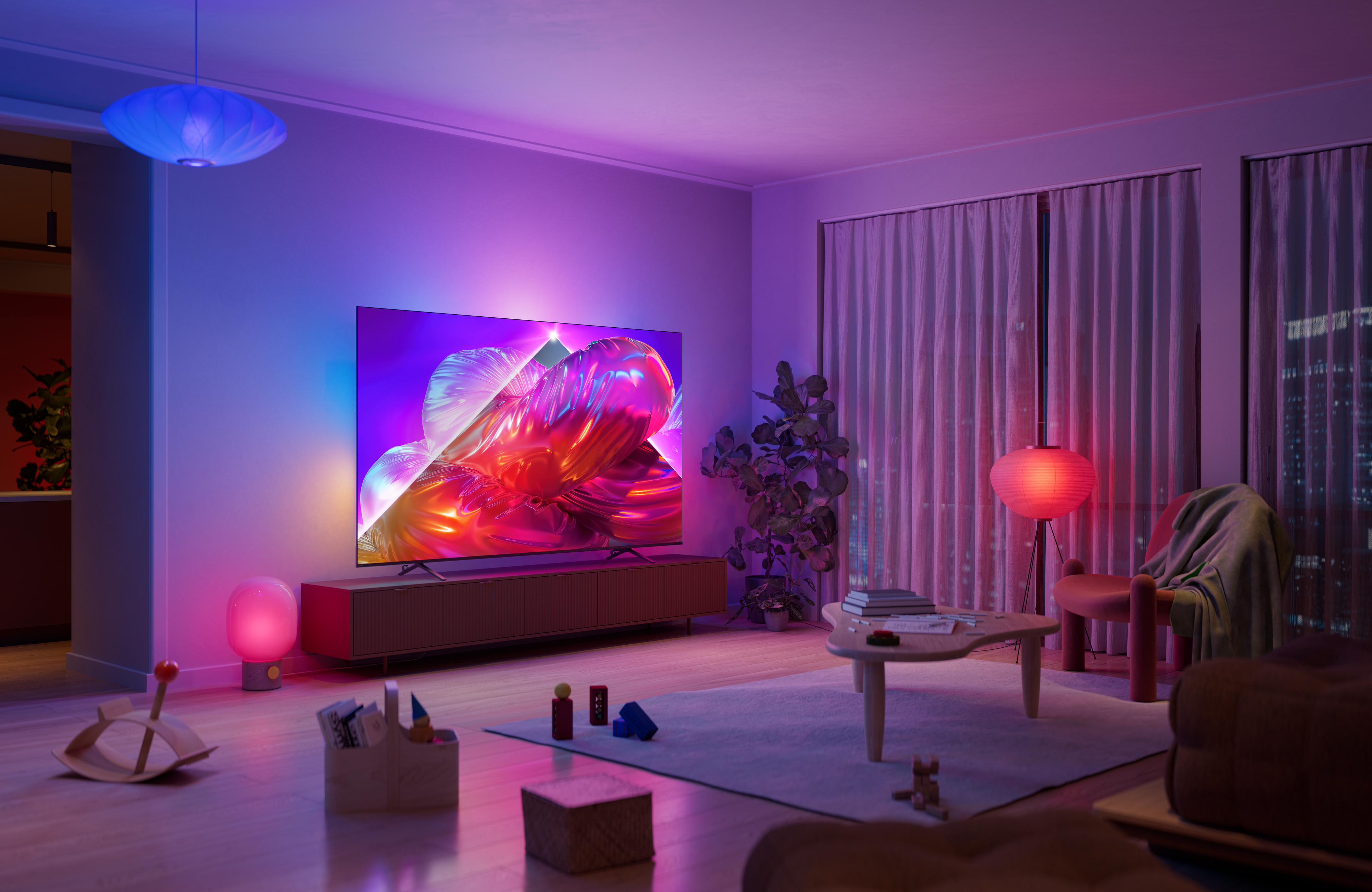 Philips Ambilight TV in a contemporary living room, displaying vibrant abstract artwork while immersive pink, purple, and blue ambient lighting extends beyond the screen and illuminates the surrounding wall.