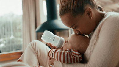 Parent kissing baby on forehead
