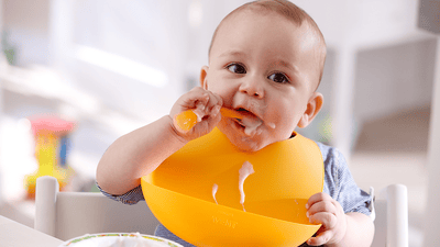 Baby tasting food and making funny face
