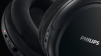 Close-up of Philips SHC5200 headphone controls and ear cushions