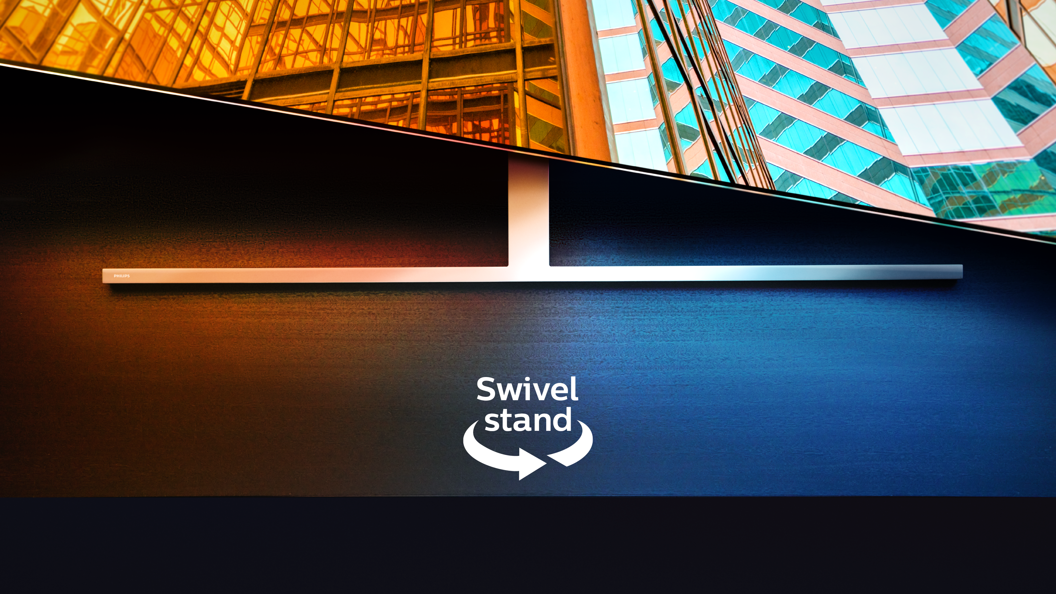 „Philips Ambilight“ televizorius ant pasukamo stovo, kuriame pavaizduotos dvi spalvingos architektūrinės scenos su rodykle ir tekstu, nurodančiu pasukimo funkciją