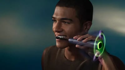 A young man brushes his teeth using a Philips Next-Generation DiamondClean electric toothbrush.