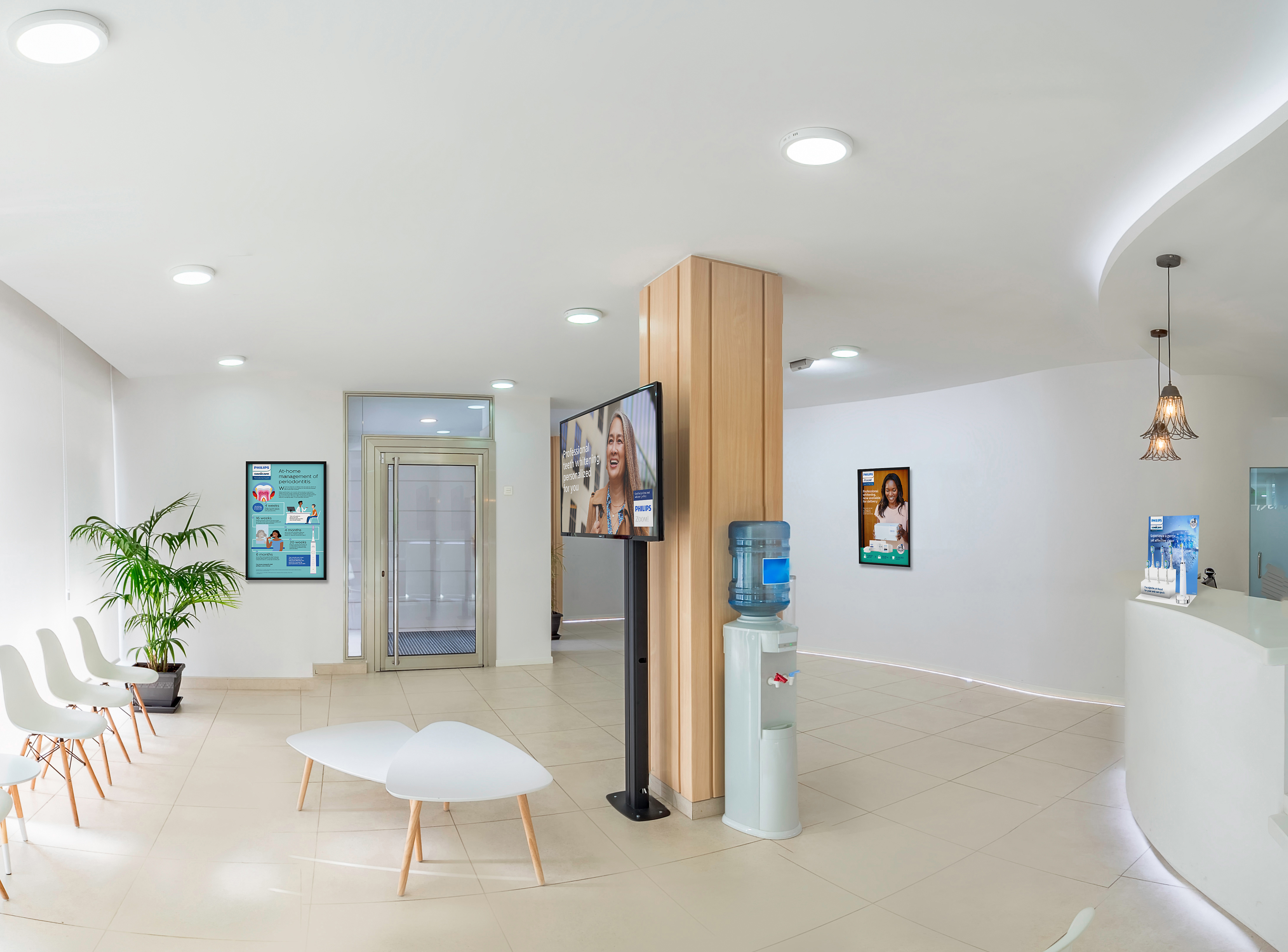 A dental practice lobby with Philips marketing on display.