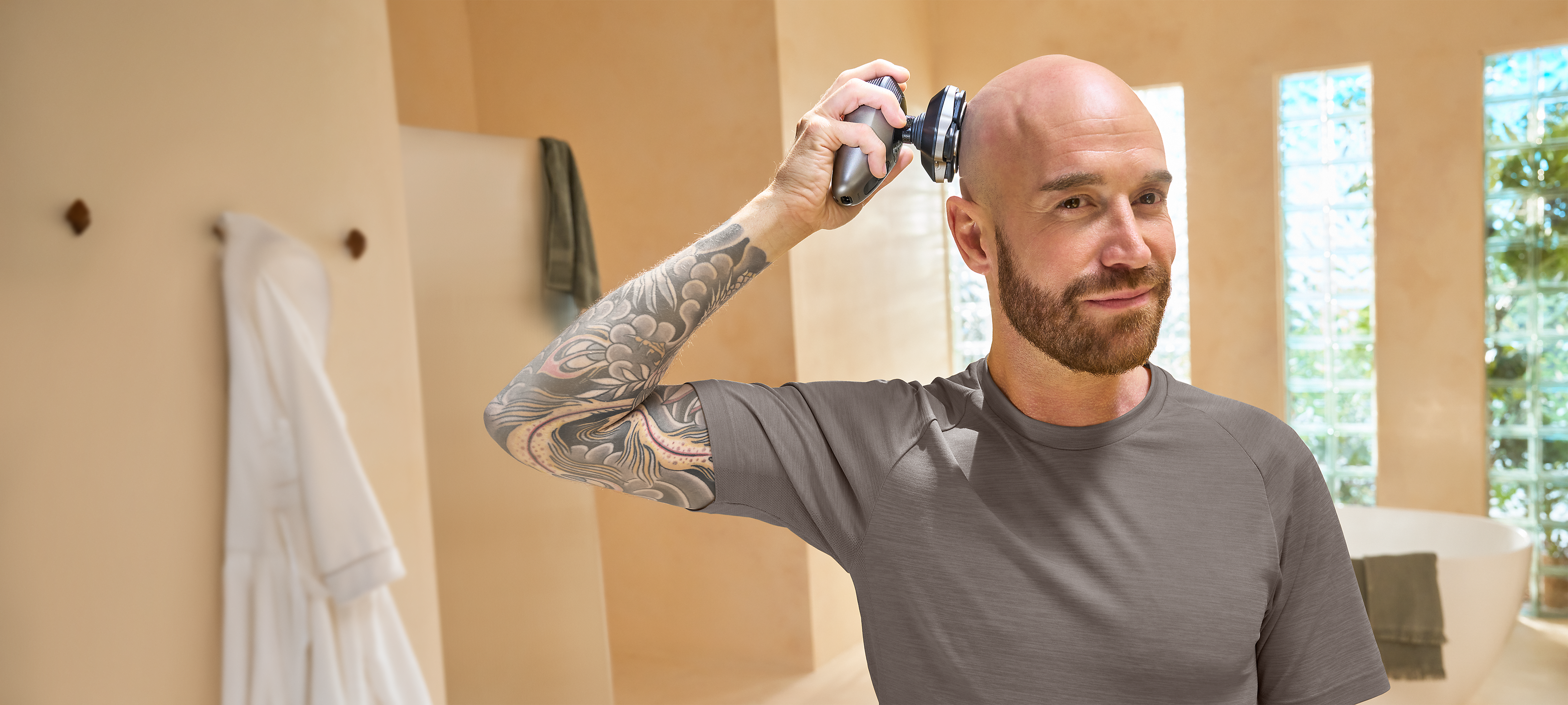 Philips 9000 Head Shaver in use in stylish bathroom