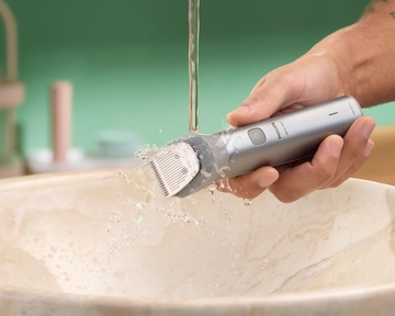 Trimmer being rinsed under running water