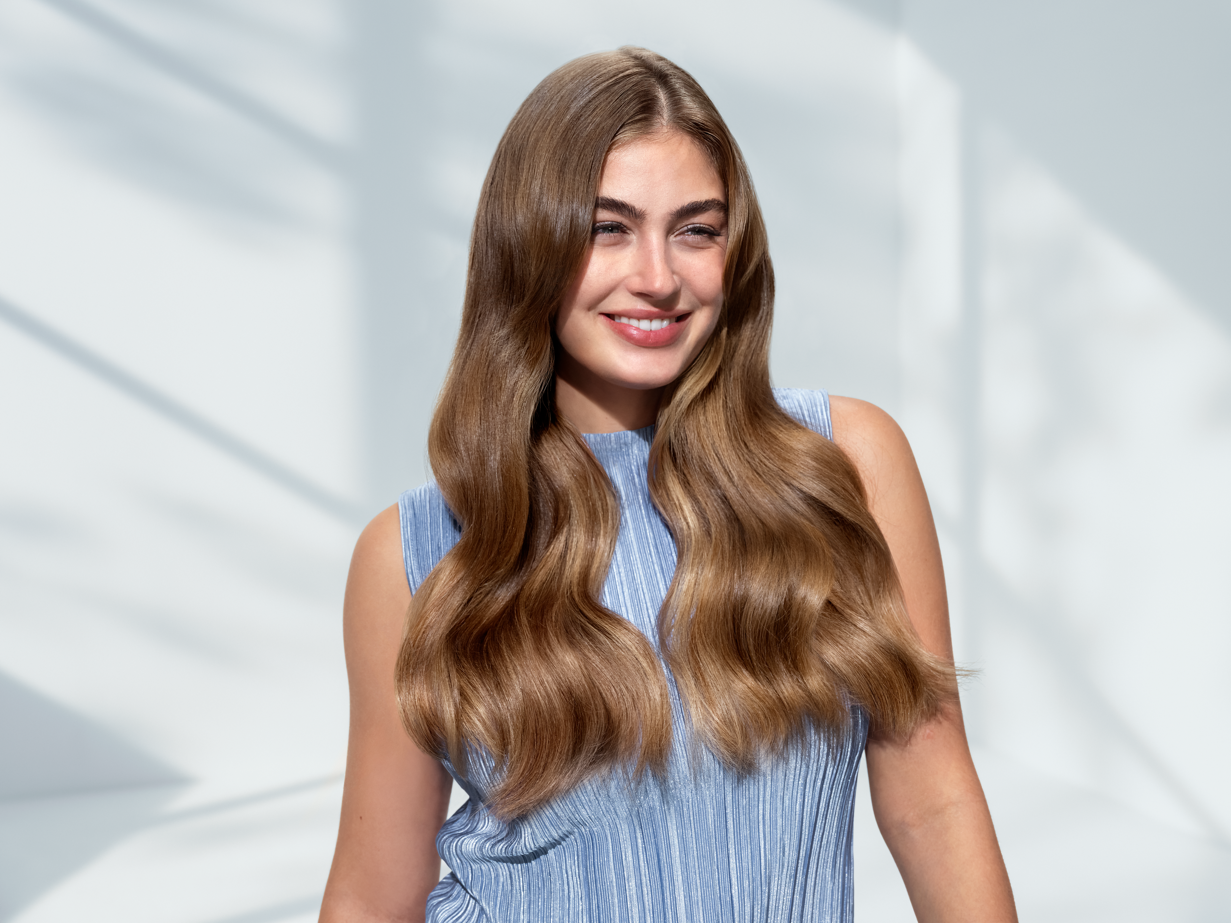 Woman with healthy hair using Philips hair dryer technology