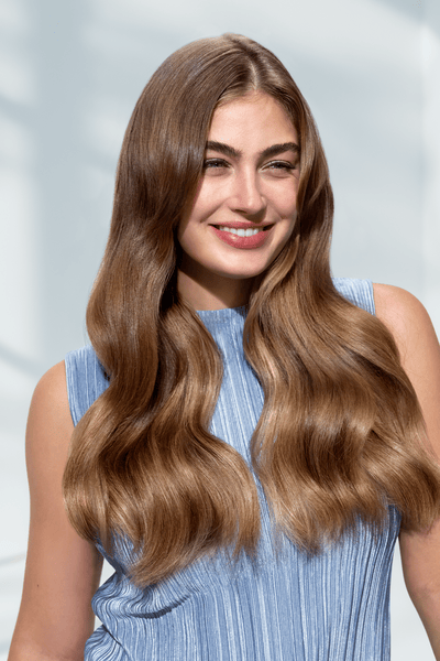 Woman with healthy hair using Philips hair dryer technology