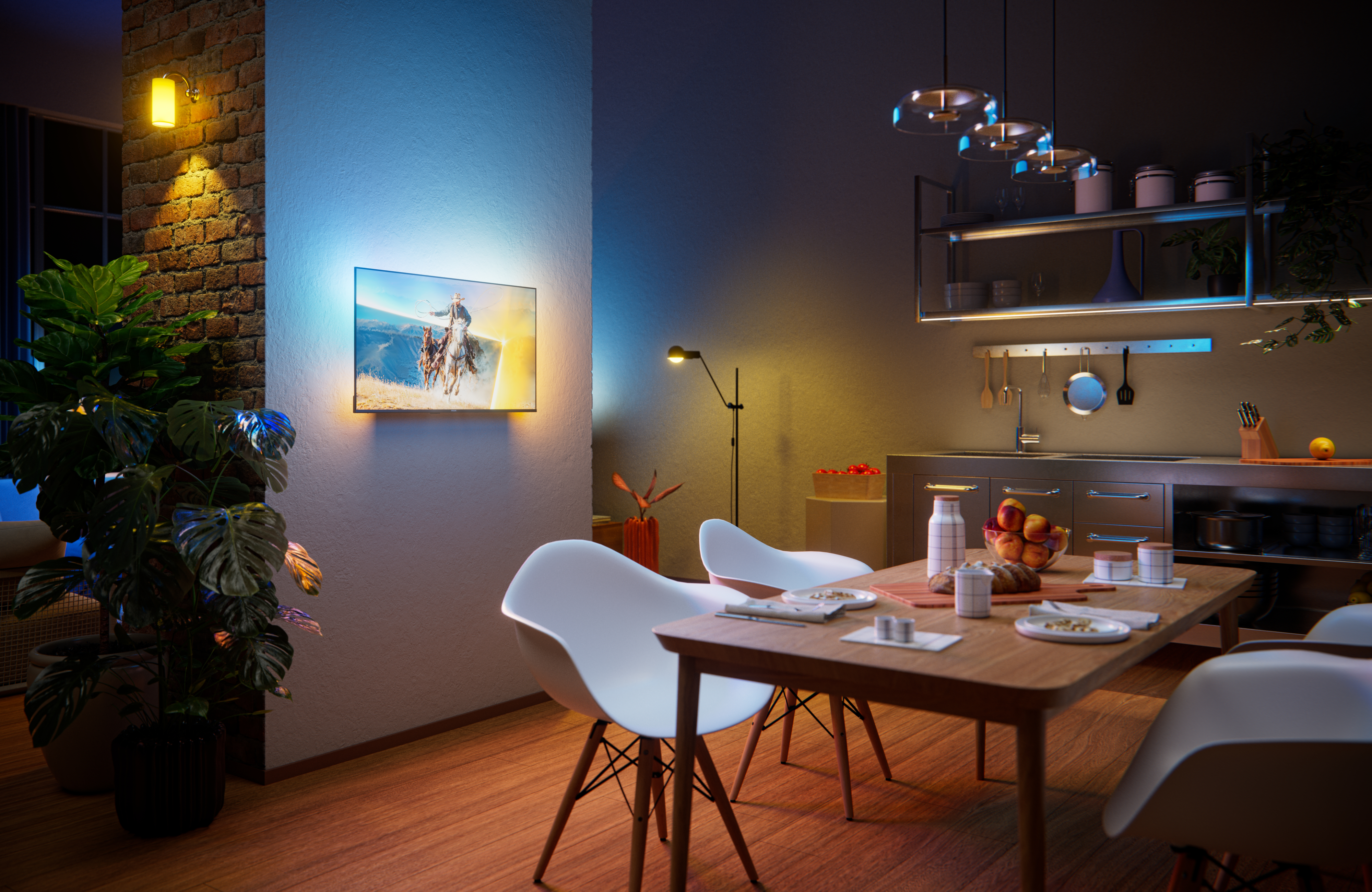 Philips Ambilight TV mounted in a modern open-plan dining and kitchen space, displaying a horseback riding scene with warm and cool ambient lighting extending onto the wall behind the screen.