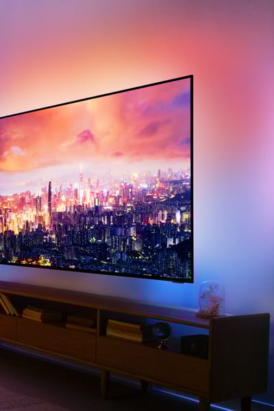 A living room featuring a Philips Ambilight TV