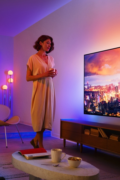 A living room featuring a Philips Ambilight TV