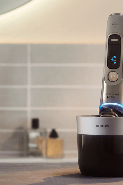 A hand holding an electric shaver