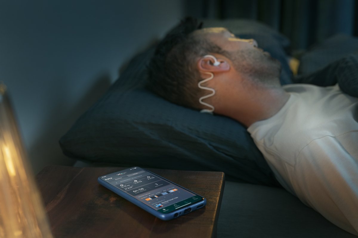 Man sleeping with Philips Sleep Headphones and the Kokoon app.