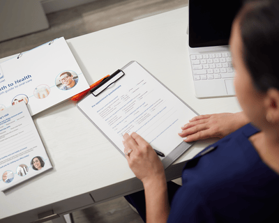 A dental professional looking at the Path to Health toolkit items