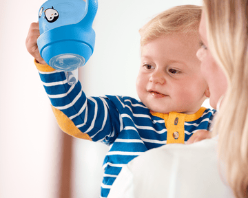 Baby holding a sippy cup
