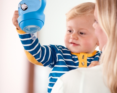 Baby holding a sippy cup