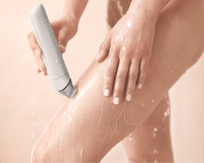 Close-up of Philips lady shaver on curved skin