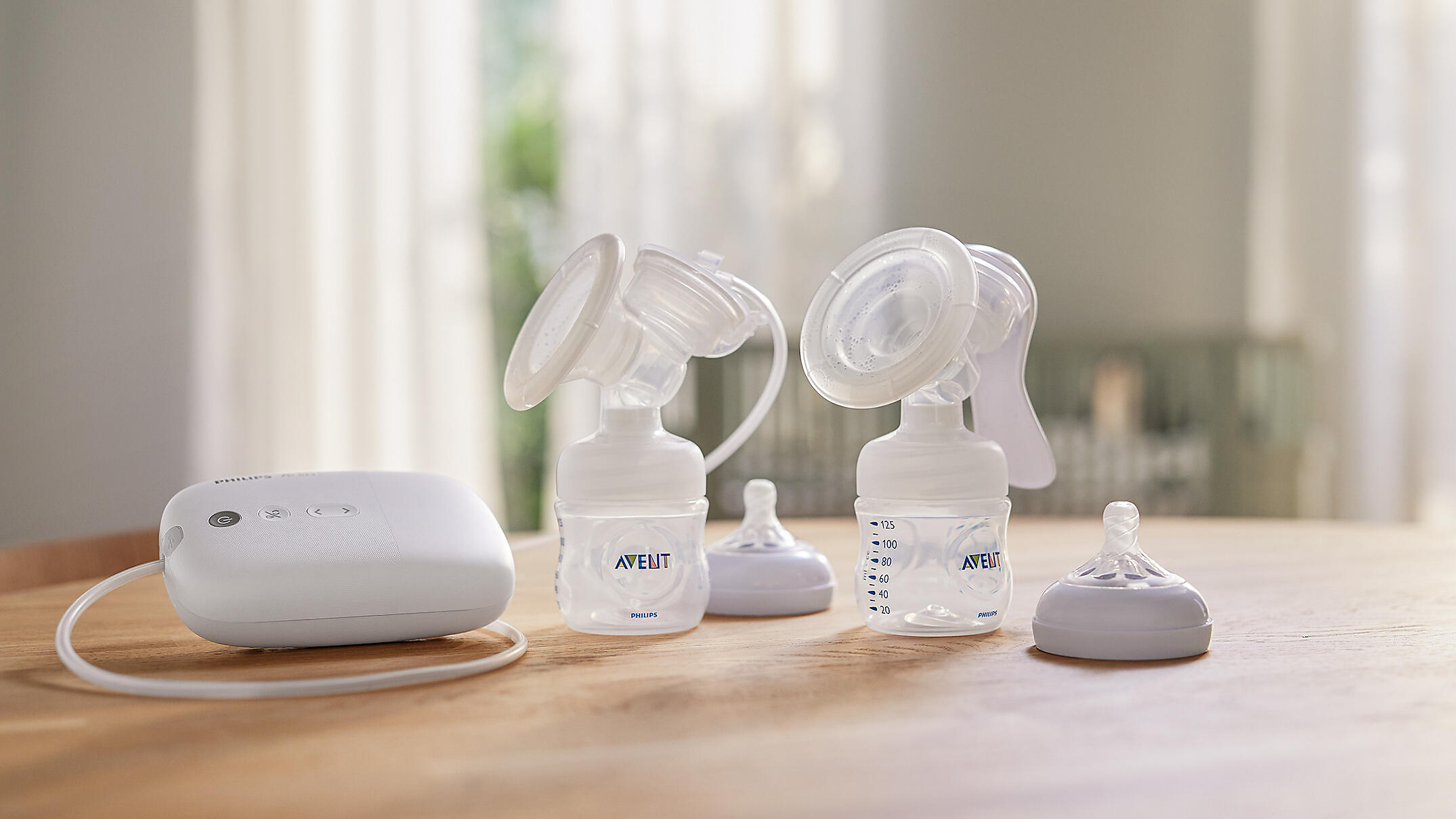 Mom talking to the phone while wearing breast pumps