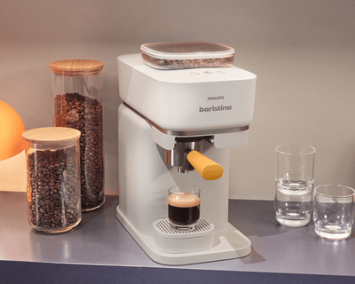 Philips Baristina brewing espresso in a cozy kitchen setup