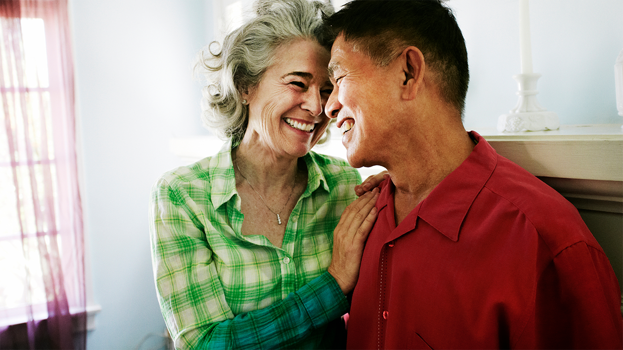 Two female companions photographed together in a relaxed home or social setting, both smiling. Their cheerful, casual appearance conveys normal daily life and represents the diet, alcohol, and lifestyle section.