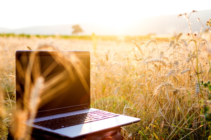 Laptop in rural wheat field with broadband internet