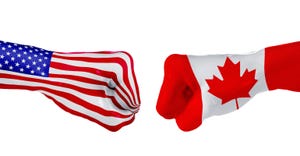 US and Canada flags in fist fight