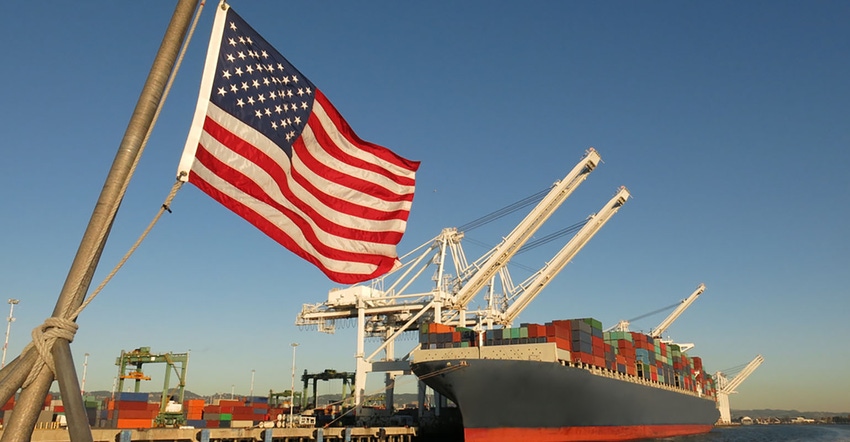 container ship with U.S. flag in foreground.
