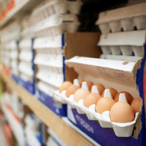 Cartons of eggs in grocery store egg case