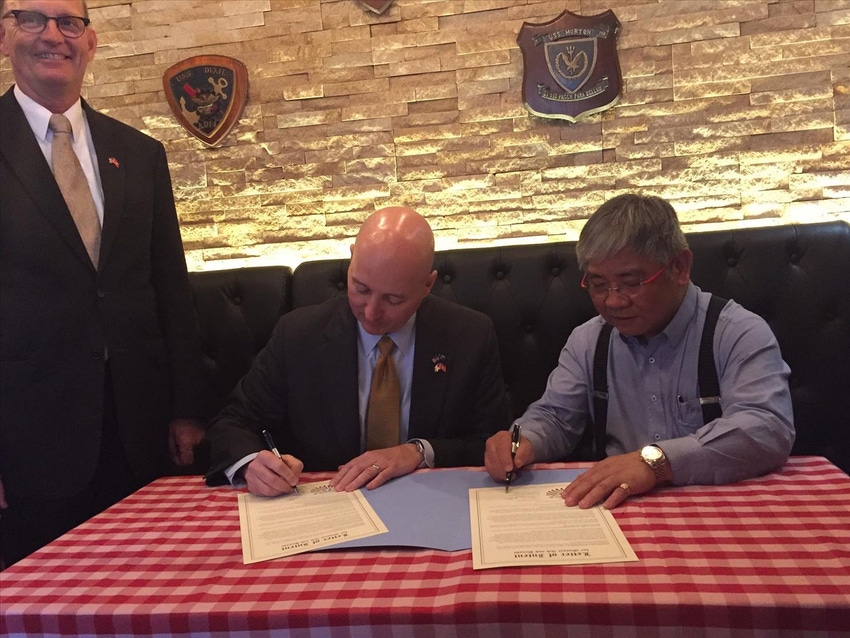 Nebraska governor signs agreements to expand beef, pork trade in China