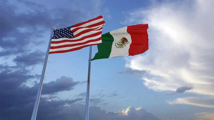United States of America and Mexico flags against sky