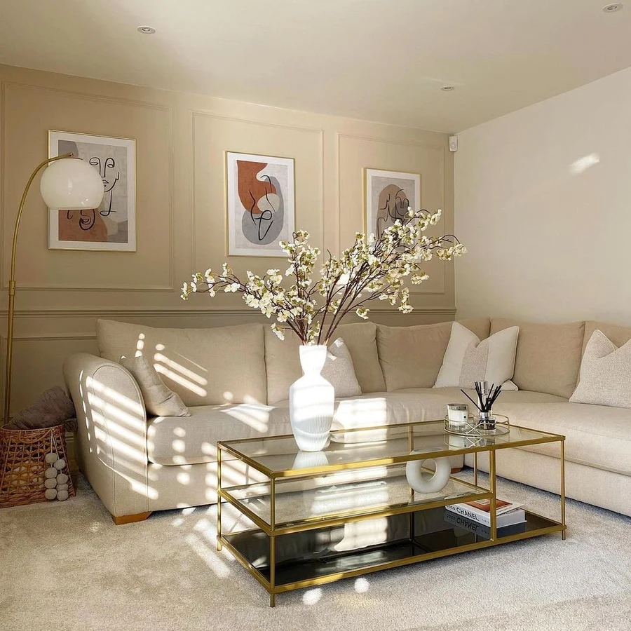 Living room image featuring sofa, coffee table, wall art and buttercream paint