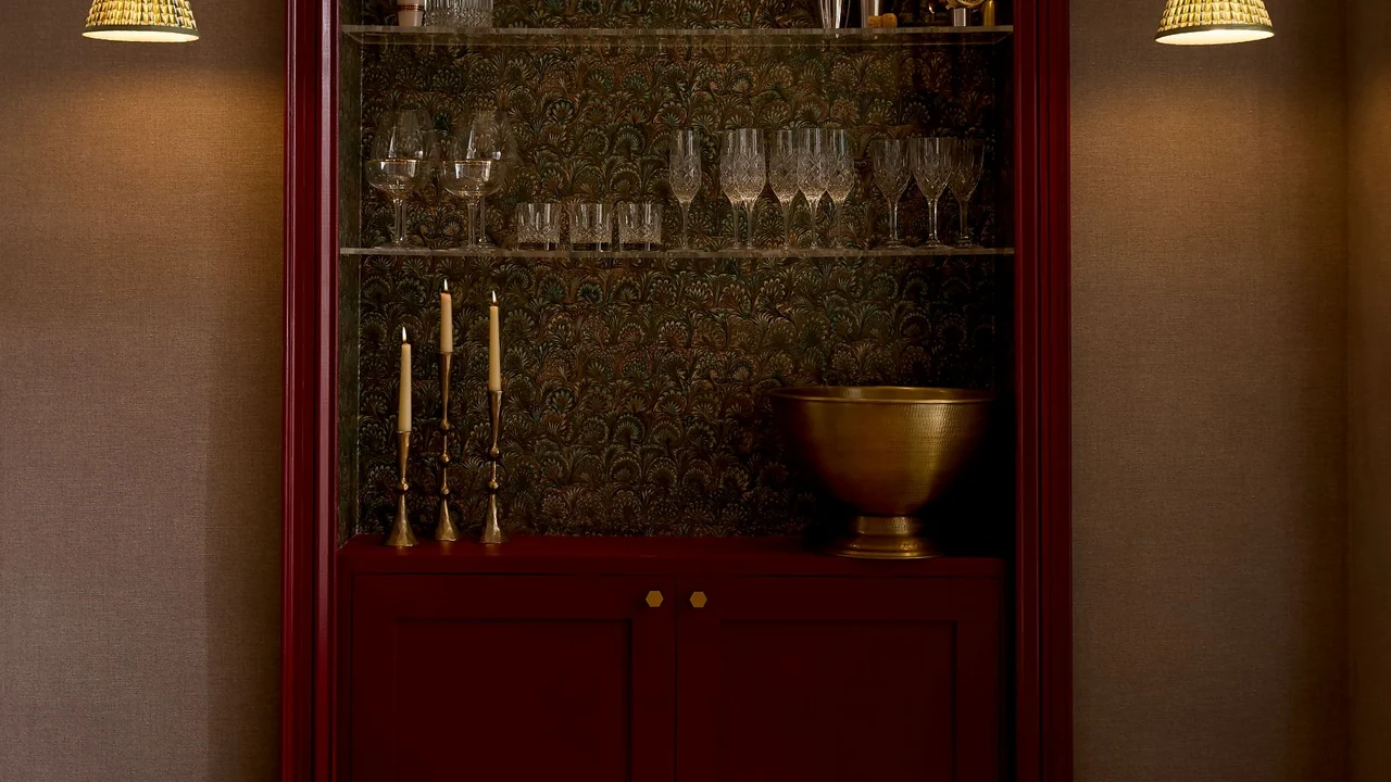 Truffle Peacock Wallpaper in a bar area partnered with Haptic Hazel Wallpaper and Roger Red Eggshell on the woodwork to create an elevated feel