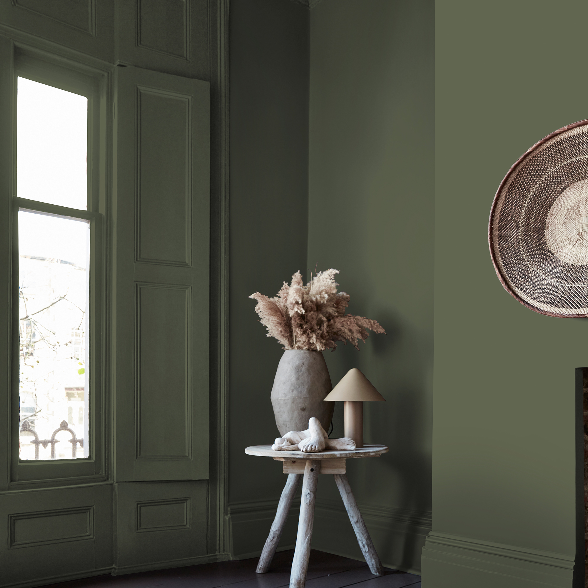 Abigail Ahern Kelp Harbour Paint in a colour drenched roomset with flowers on a table