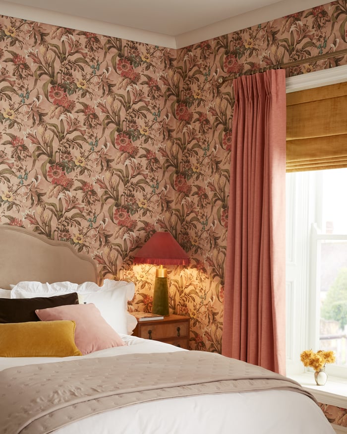 Elements Sunset roman blind paired with Wallace Peach curtains in a bedroom setting
