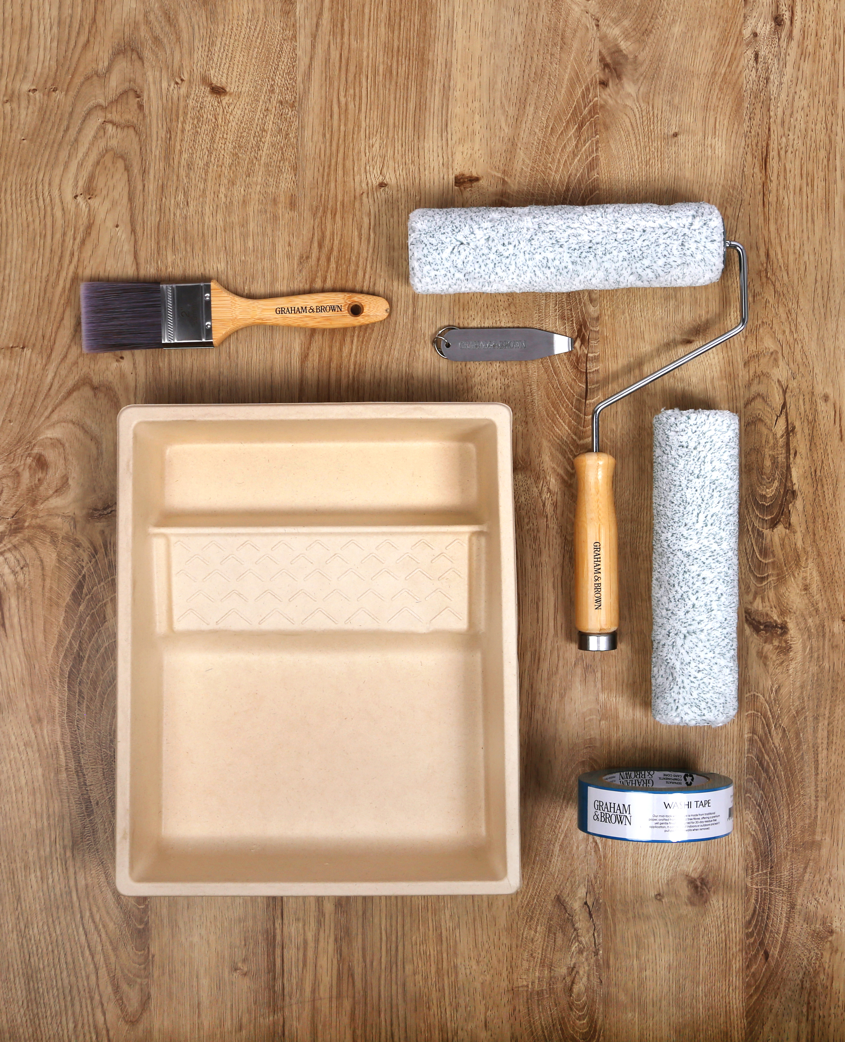 image of paint kit including paint tray, paint roller, paint brush, masking tape and tin opener