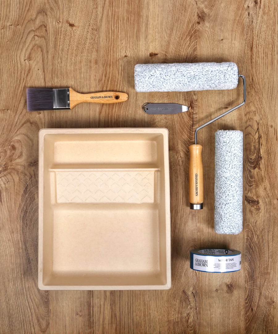 image of paint kit including paint tray, paint roller, paint brush, masking tape and tin opener