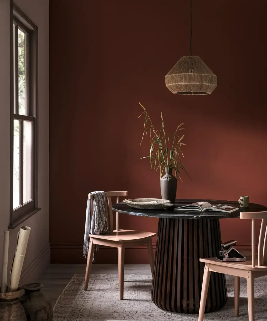 Dining room with table and chairs and pimento resistance paint on the wall
