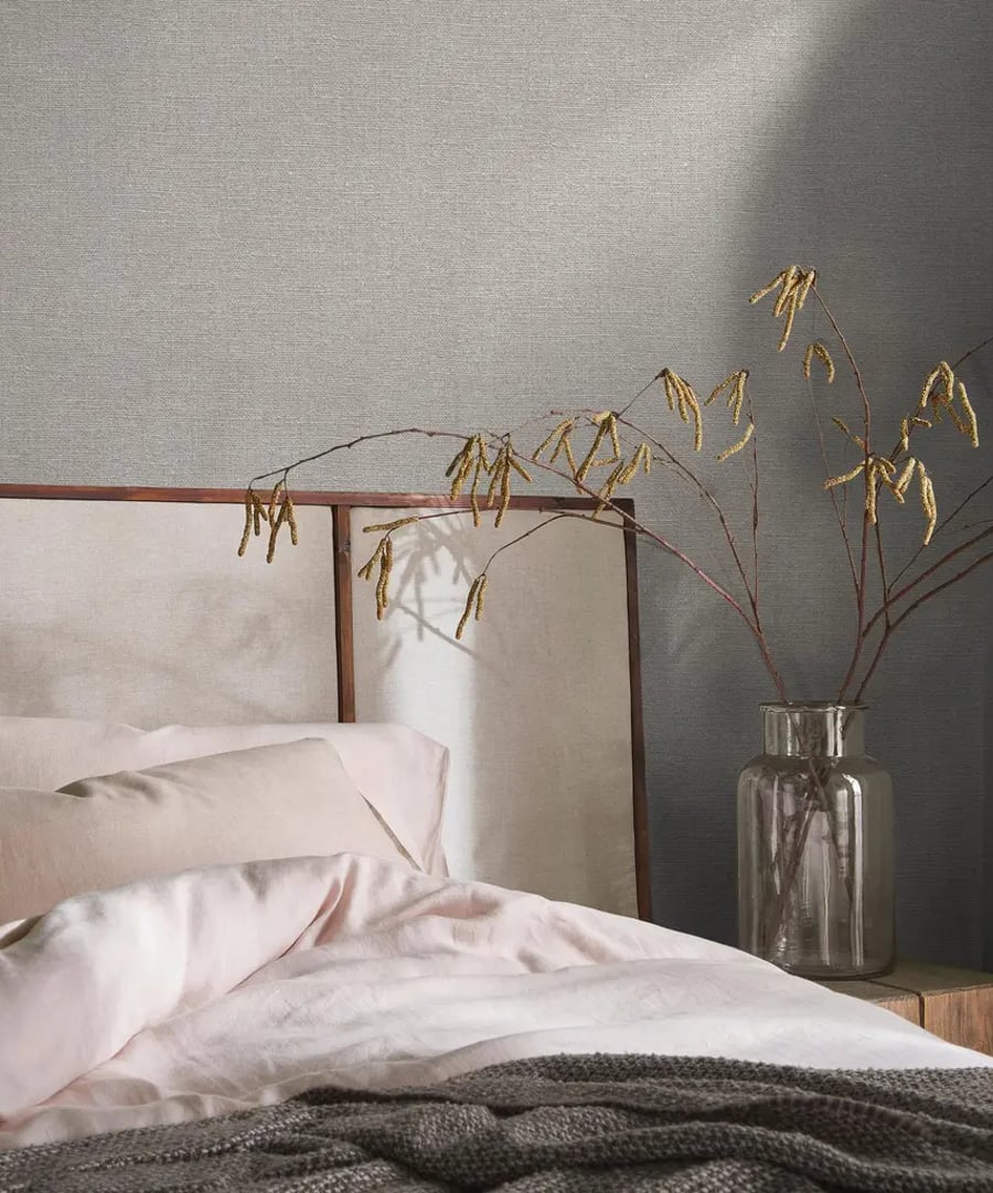bedroom room set with bed, vase and haptic linen wallpaper