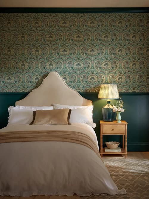 Room set image of bedroom featuring paisley tapestry wallpaper