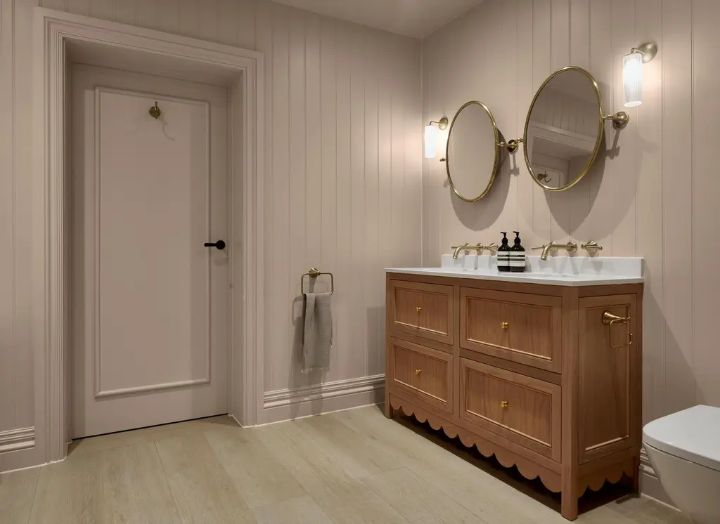 Room set of a bathroom cabinet and mirrors featuring whispering rose paint